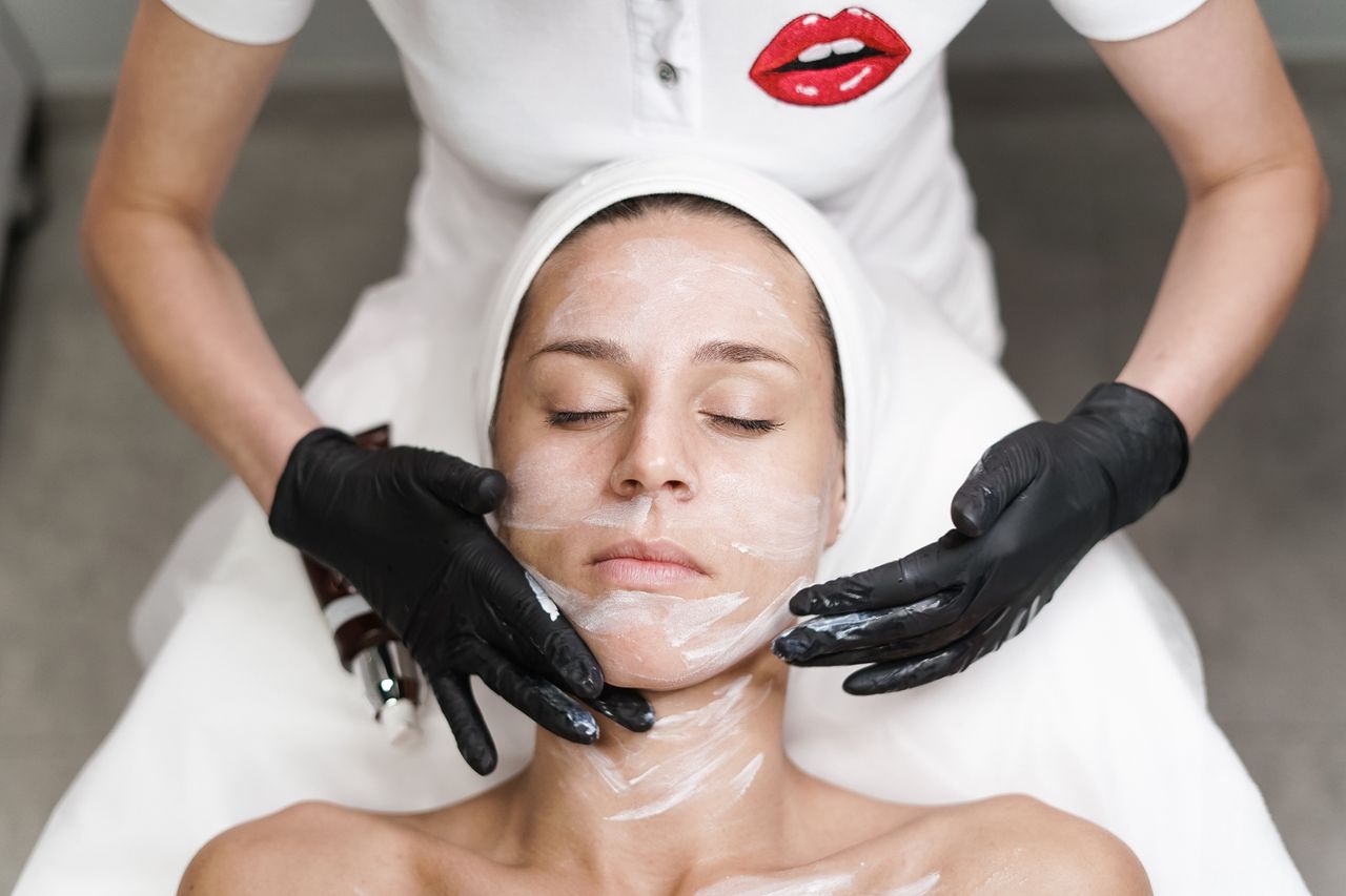 Crafting Captivating Headlines: Your awesome post title goes here Woman receiving a facial treatment at spa, with beautician applying mask in a relaxing setting.