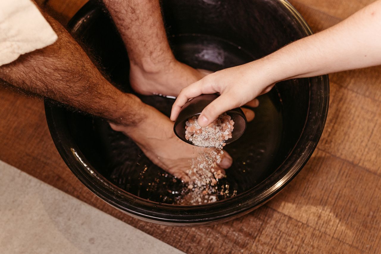 The Art of Drawing Readers In: Your attractive post title goes here Man enjoying a soothing foot soak with Himalayan salt in a relaxing spa setting.