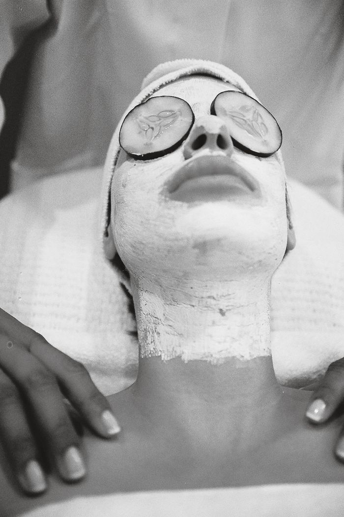 why-choose-us-01 A person enjoying a soothing spa facial with a white mask and cucumber slices over eyes.